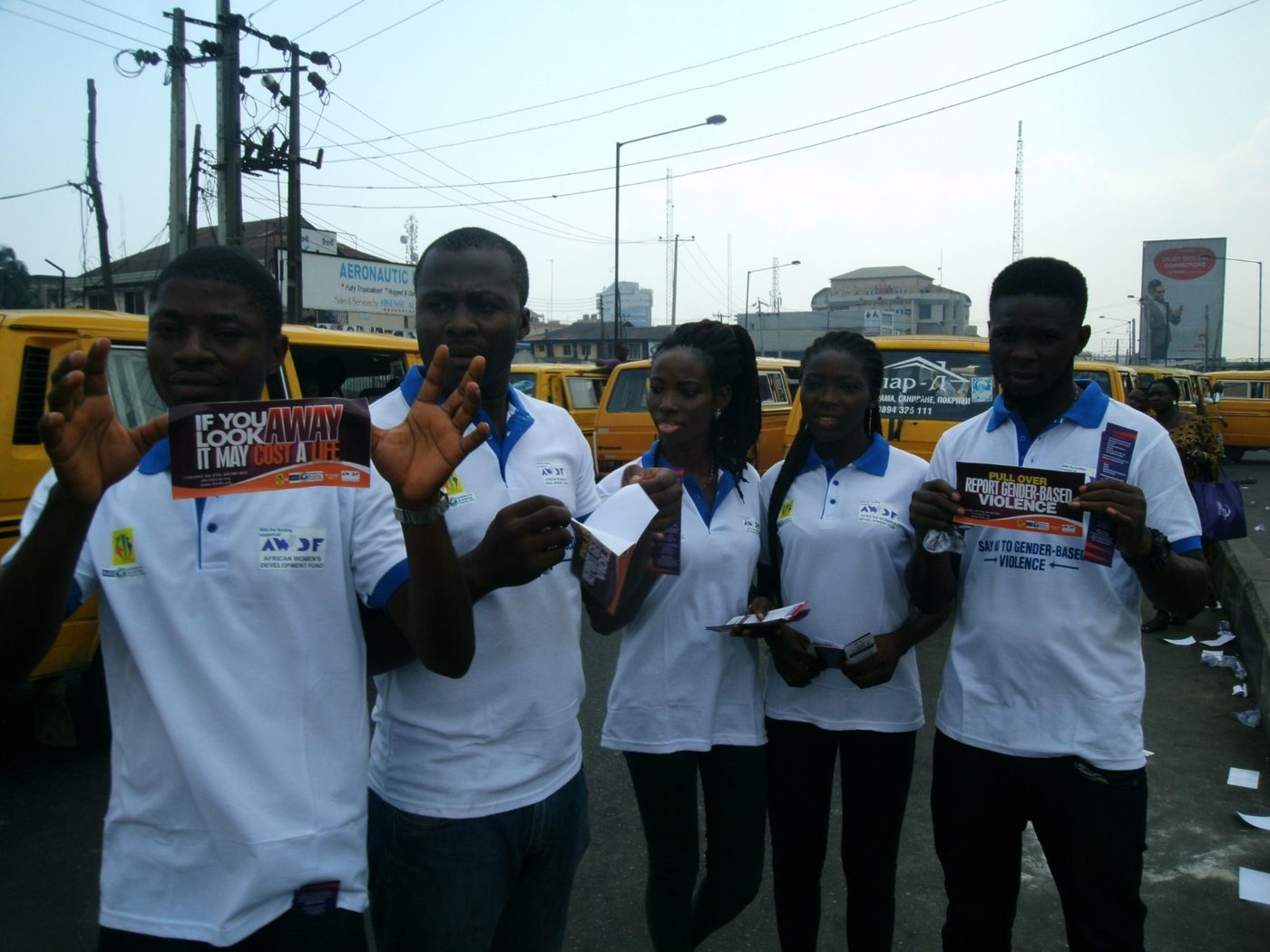 IforSFU volunteers in branded shirts holding campaign leaflets at Tejuosho Market, Lagos, November 2015